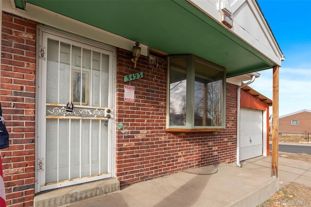 view of exterior entry with a garage