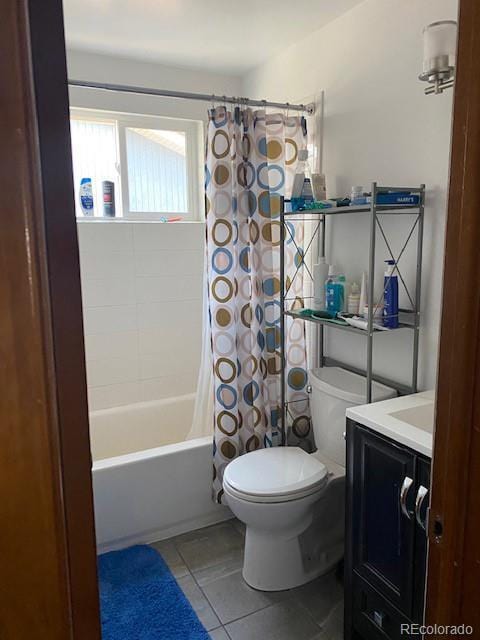 bathroom featuring vanity, shower / tub combo with curtain, tile patterned floors, and toilet
