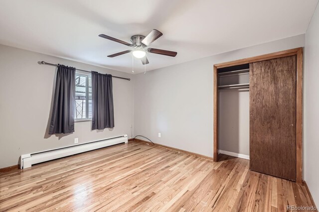 1824 S Columbine St, Denver, CO 80210 - unfurnished bedroom featuring baseboard heating, wood finished floors, a closet, and baseboards