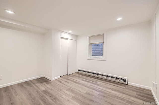 1824 S Columbine St, Denver, CO 80210 - basement featuring a baseboard heating unit, wood finished floors, recessed lighting, and baseboards