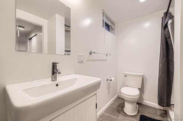 1824 S Columbine St, Denver, CO 80210 - bathroom with toilet, baseboards, and vanity