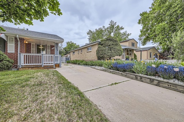1824 S Columbine St, Denver, CO 80210 - view of side of property with covered porch and brick siding