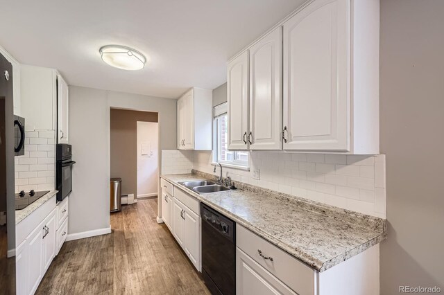 1824 S Columbine St, Denver, CO 80210 - kitchen featuring black appliances, a sink, wood finished floors, decorative backsplash, and white cabinets