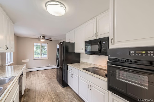 1824 S Columbine St, Denver, CO 80210 - kitchen with black appliances, a baseboard heating unit, tasteful backsplash, white cabinets, and light wood-type flooring