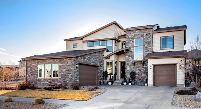 view of front facade with stone siding, concrete driveway, and an attached garage