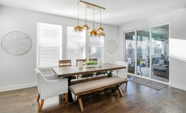 dining space with baseboards and wood finished floors