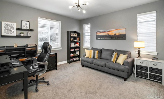 carpeted office space with an inviting chandelier and baseboards