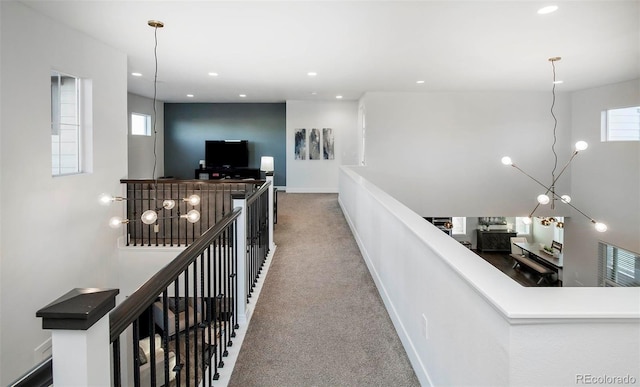 hall with recessed lighting, baseboards, carpet flooring, and an upstairs landing