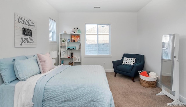 bedroom featuring carpet floors, visible vents, and baseboards