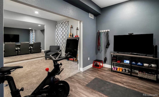 workout room with recessed lighting, visible vents, baseboards, and wood finished floors