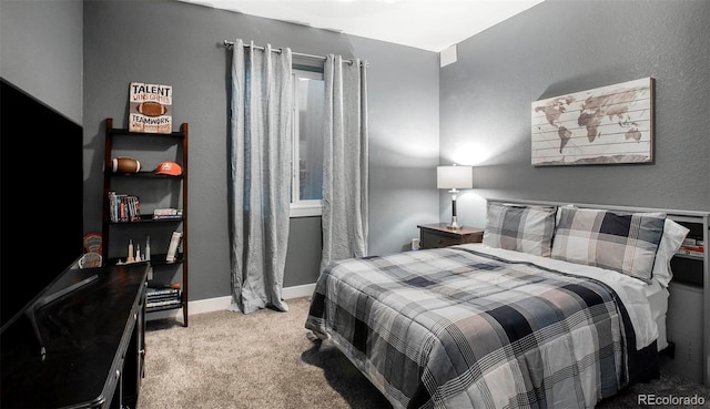 carpeted bedroom featuring baseboards