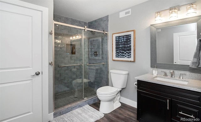 full bathroom with toilet, a shower stall, visible vents, and vanity