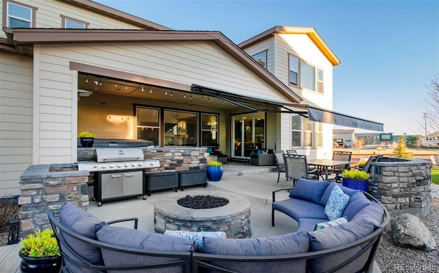 view of patio / terrace with outdoor dining space, a grill, exterior kitchen, and an outdoor living space with a fire pit