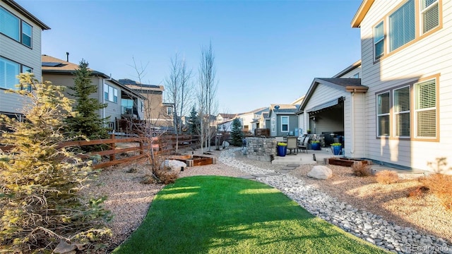 view of yard with a patio area, a residential view, and fence