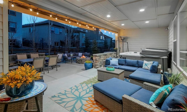 view of patio / terrace with an outdoor living space with a fire pit