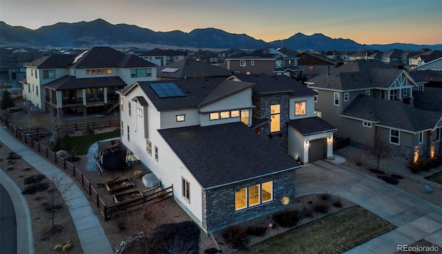 aerial view at dusk with a mountain view and a residential view