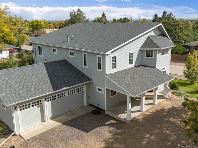 rear view of house with a garage