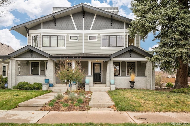 1401 S Clarkson St, Denver, CO 80210 - view of front facade with a front yard, a porch, and brick siding