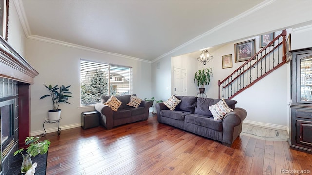 living room with ornamental molding, a tiled fireplace, dark hardwood / wood-style floors, and lofted ceiling