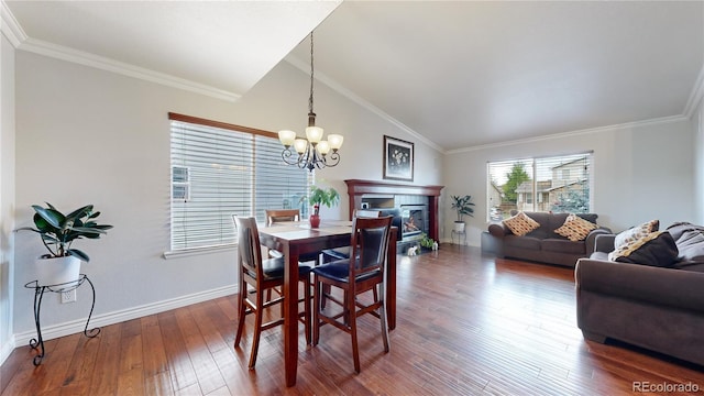 dining area with lofted ceiling, crown molding, and dark hardwood / wood-style floors