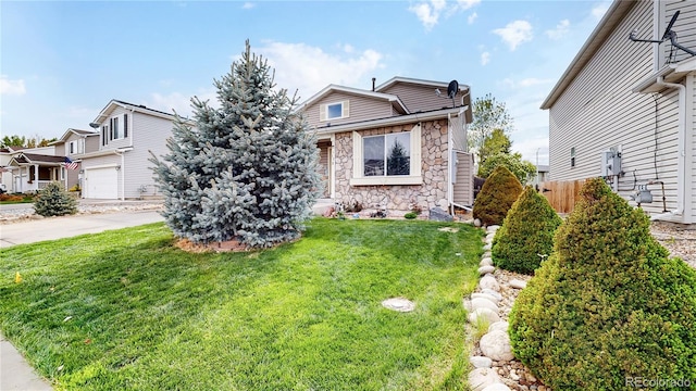 view of front of property with a front yard and a garage