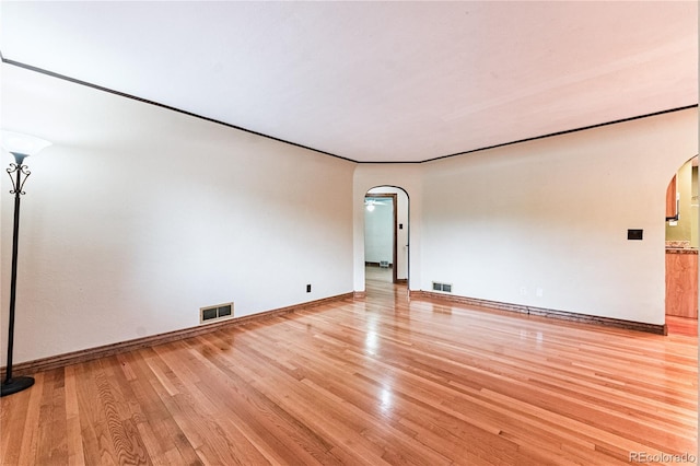 1325 N Foote Ave, Colorado Springs, CO 80909 - spare room with arched walkways, light wood finished floors, and baseboards