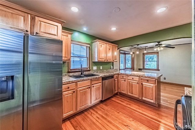 1325 N Foote Ave, Colorado Springs, CO 80909 - kitchen with appliances with stainless steel finishes, a sink, light wood-style flooring, a peninsula, and healthy amount of natural light