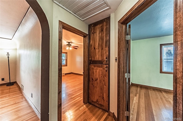 1325 N Foote Ave, Colorado Springs, CO 80909 - hallway with light wood-style flooring, arched walkways, and baseboards
