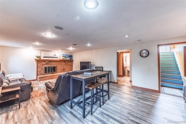 1325 N Foote Ave, Colorado Springs, CO 80909 - living room with wood finished floors, stairway, baseboards, a textured ceiling, and recessed lighting