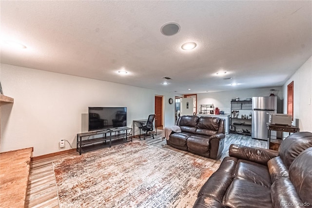 1325 N Foote Ave, Colorado Springs, CO 80909 - living area featuring wood finished floors, a textured ceiling, and baseboards