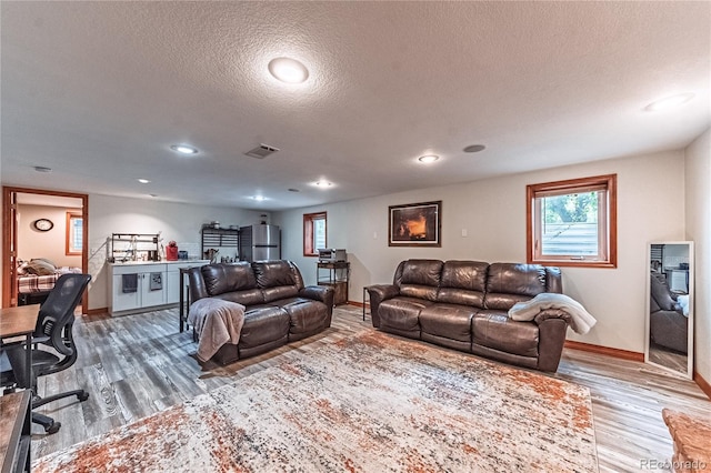 1325 N Foote Ave, Colorado Springs, CO 80909 - living room with wood finished floors, baseboards, a textured ceiling, and recessed lighting