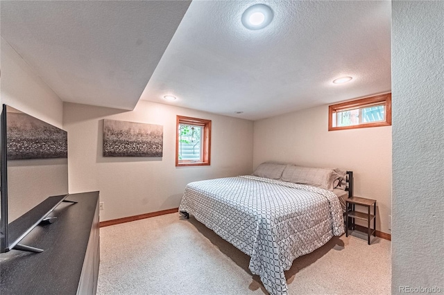 1325 N Foote Ave, Colorado Springs, CO 80909 - bedroom featuring carpet, a textured ceiling, multiple windows, a textured wall, and baseboards