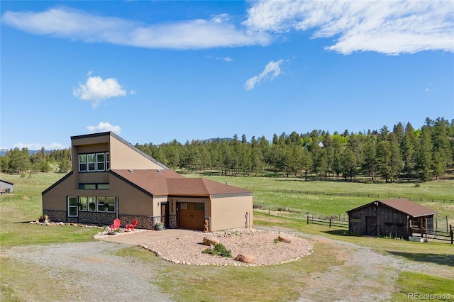 1819 Nova Rd, Pine, CO 80470 - view of front of property with a garage, gravel driveway, and stucco siding