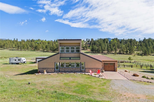 1819 Nova Rd, Pine, CO 80470 - view of front of house with an attached garage, concrete driveway, stucco siding, and stone siding