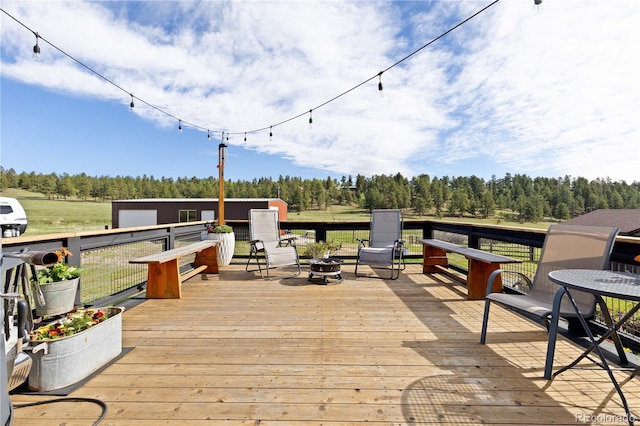 1819 Nova Rd, Pine, CO 80470 - wooden terrace with a fire pit and view of wooded area