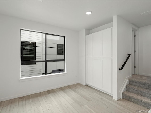 empty room featuring light wood-style floors and baseboards