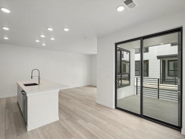 kitchen with recessed lighting, visible vents, a sink, and light wood-style flooring