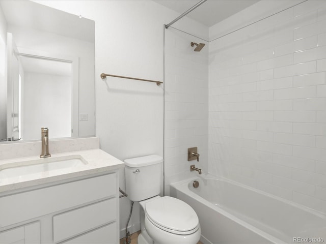 bathroom with bathtub / shower combination, vanity, and toilet