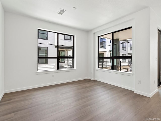 2036 S Holly St Unit 4, Denver, CO 80222 - empty room with baseboards, wood finished floors, and visible vents