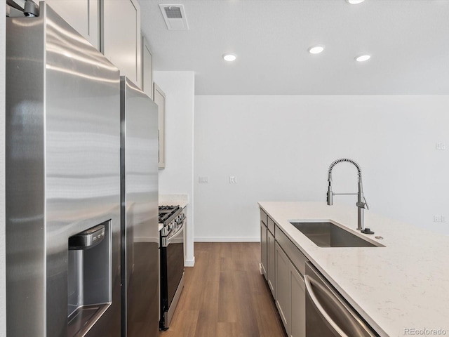 2036 S Holly St Unit 4, Denver, CO 80222 - kitchen with stainless steel appliances, visible vents, a sink, light stone countertops, and dark wood-style flooring