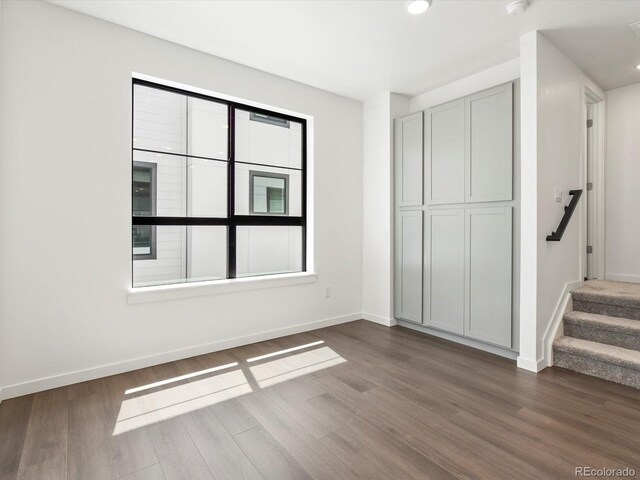 2036 S Holly St Unit 4, Denver, CO 80222 - unfurnished bedroom with baseboards, recessed lighting, and dark wood-style flooring