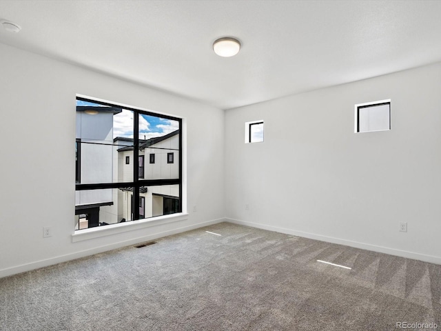 2036 S Holly St Unit 4, Denver, CO 80222 - unfurnished room featuring visible vents, baseboards, and carpet floors