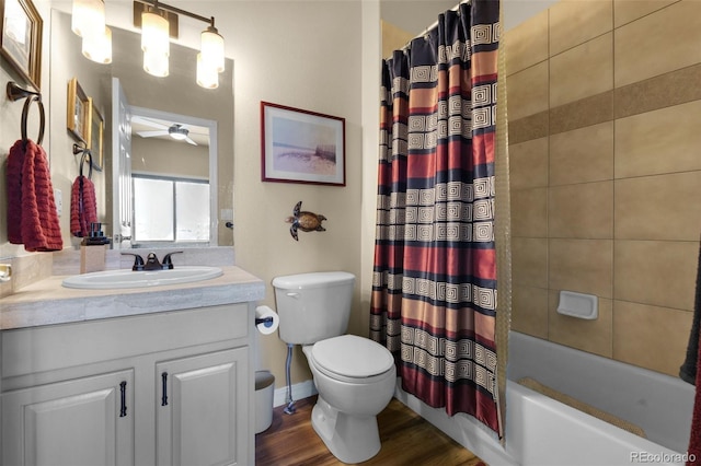 bathroom with toilet, vanity, shower / bath combo, wood finished floors, and a ceiling fan