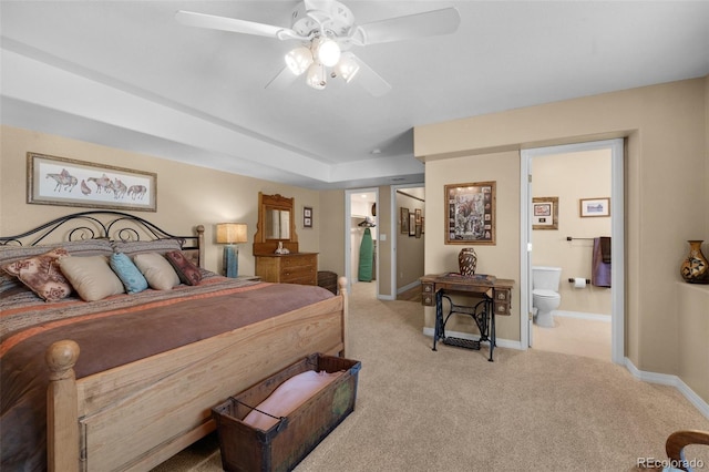 carpeted bedroom with baseboards, ensuite bathroom, and ceiling fan