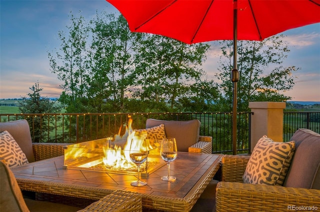 deck at dusk with an outdoor fire pit