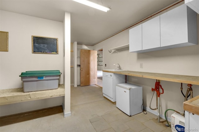 kitchen featuring refrigerator, white cabinetry, butcher block counters, open shelves, and a sink