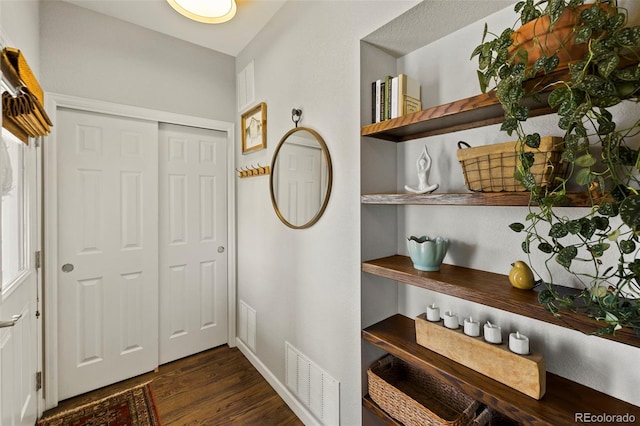 entrance foyer featuring dark wood-style floors and visible vents