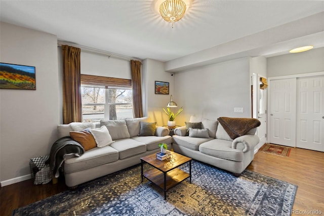 living room featuring baseboards and wood finished floors