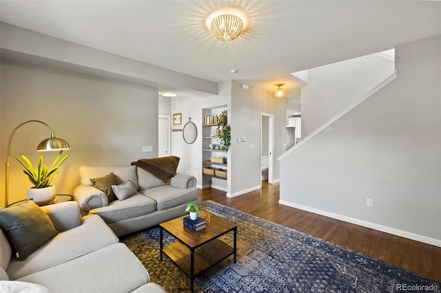 living room with stairs, baseboards, and wood finished floors