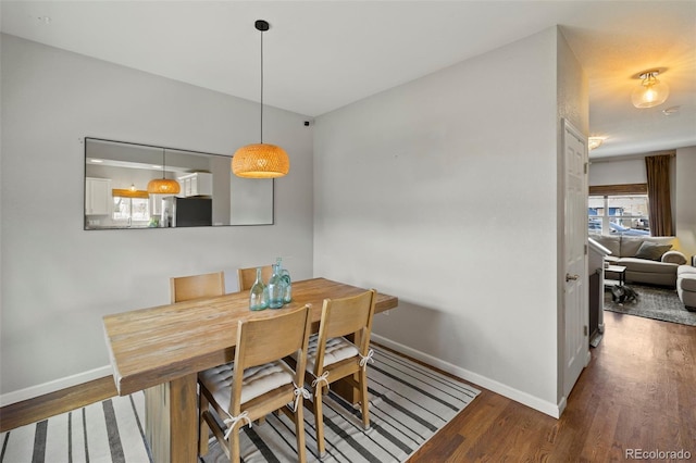 dining room with wood finished floors and baseboards